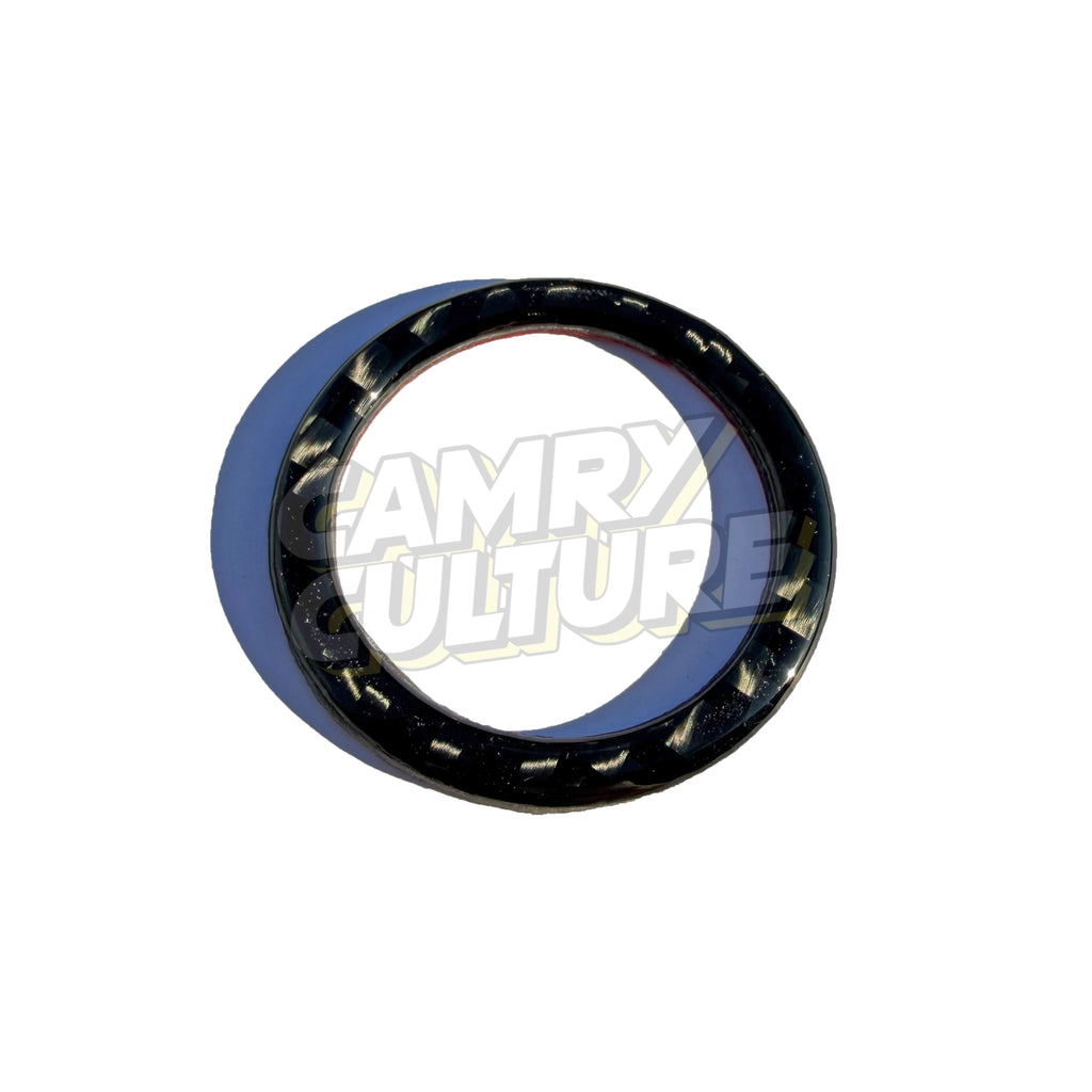 A black circular mechanical ring or seal with visible inner and outer rings, photographed on a plain white background. A large semi-transparent 'CAMRY CULTURE' watermark overlays the center of the product. Made for the 2018, 2019, 2020, 2021, 2022, 2023, and 2024 Toyota Camry SE, XSE, LE, XLE, and TRD.