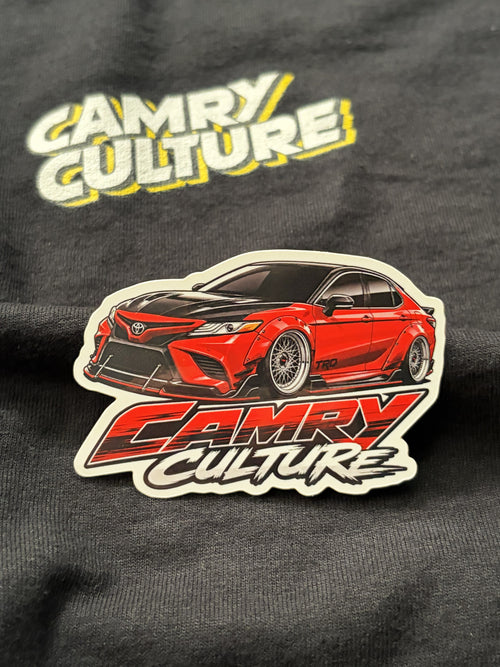 A die cut red sticker of a XV70 Toyota Camry on top of an official Camry Culture shirt. 