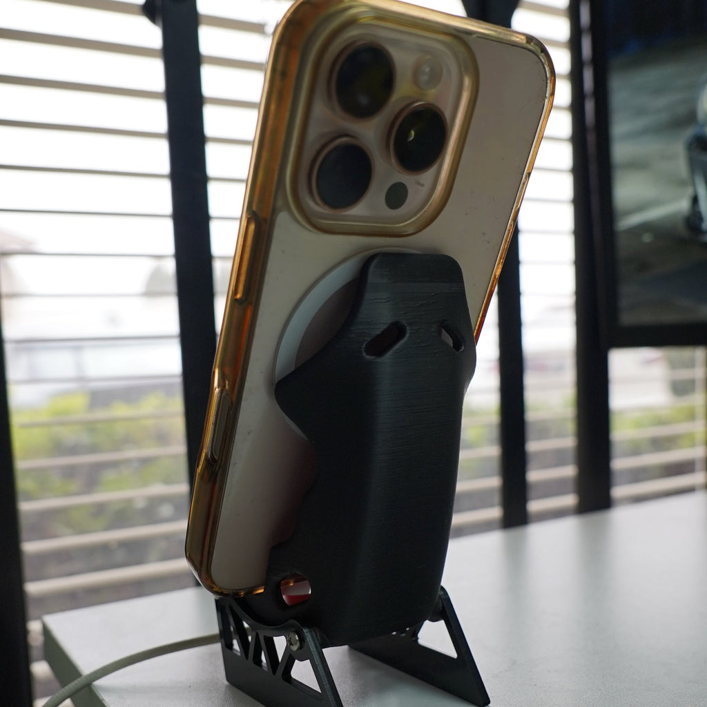 Smartphone with a protective case on a stand against a window background